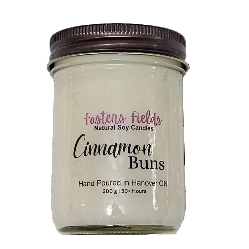 white soy wax poured into a jam jar with a copper lid, cinnamon buns scent, clear simple label