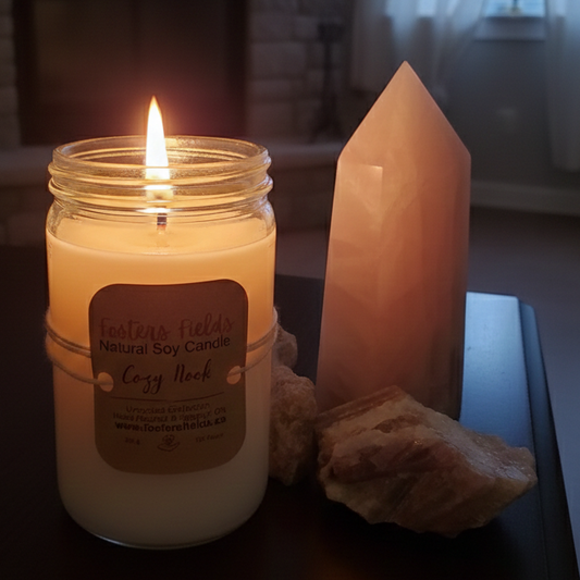 Simple white soy candle, poured in an old fashioned jar with a simple kraft label. Tied on with jud. Set in a home setting, relaxing fire in a cozy room