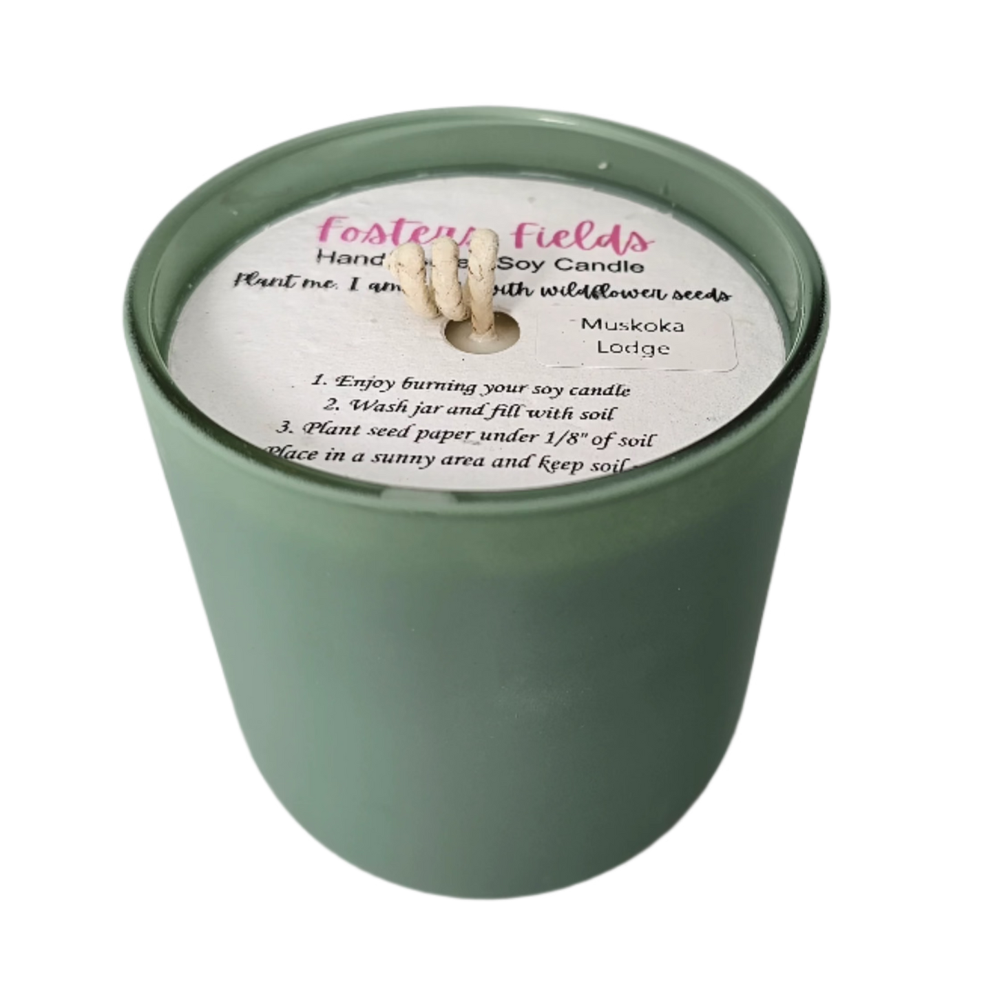Candle in rich green vessel with warm, woodsy Muskoka Lodge fragrance