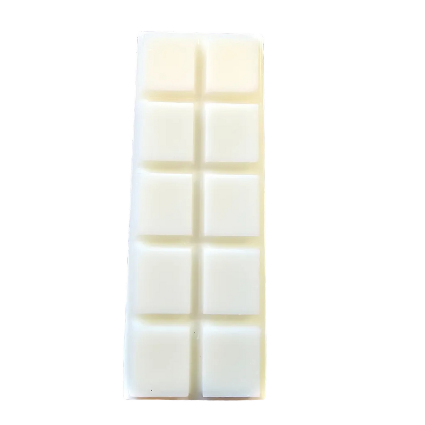 White chocolate bar with a grid pattern on a black surface