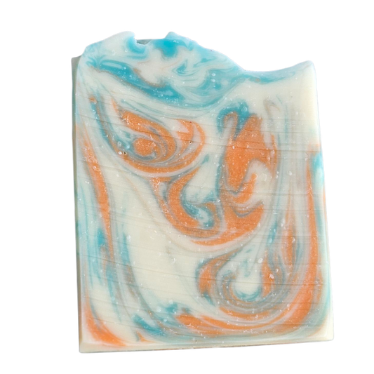 Swirled soap bar with green and orange patterns on a white , background, Orange Ginger Handmade Soap Bar