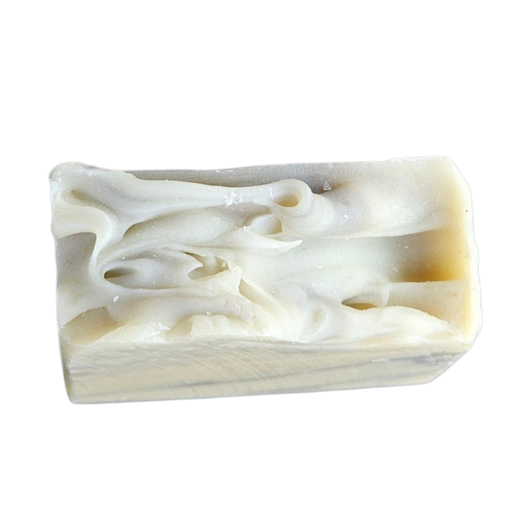 Bar of soap with swirl pattern on a white background, top view of Bergamot Patchouli handmade soap