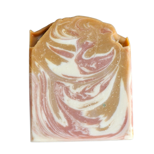 Swirled soap bar with gold, white, and pink colors on a white background