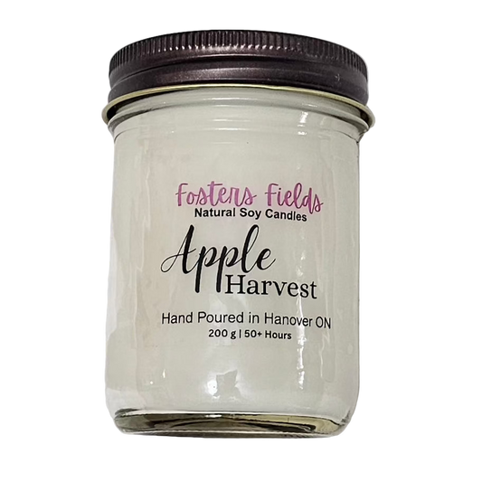 White soy wax poured in a jam jar with a copper lid, simple clear label for Apple Harvest scented candle