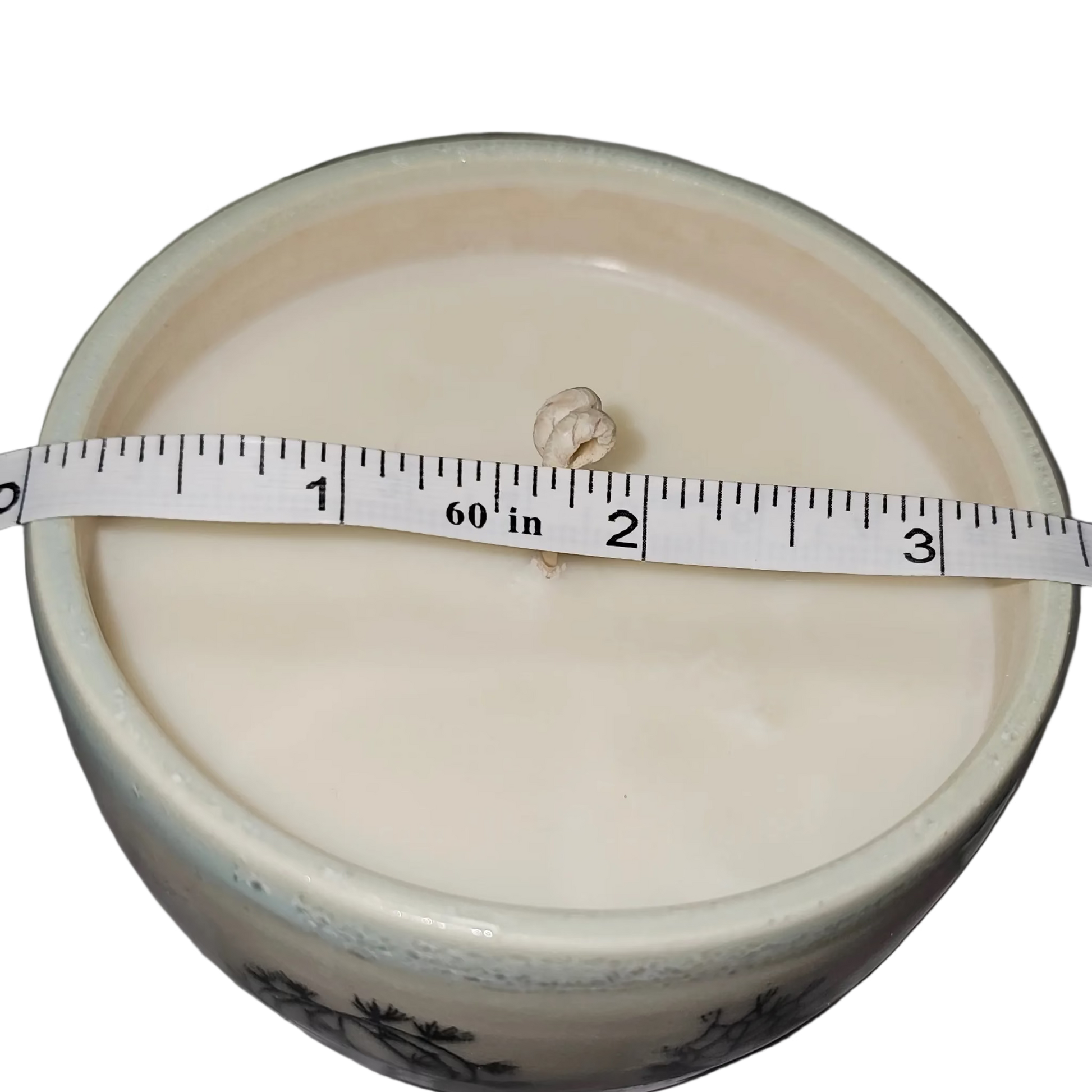 White container with a measuring tape on a gray surface, soy candle