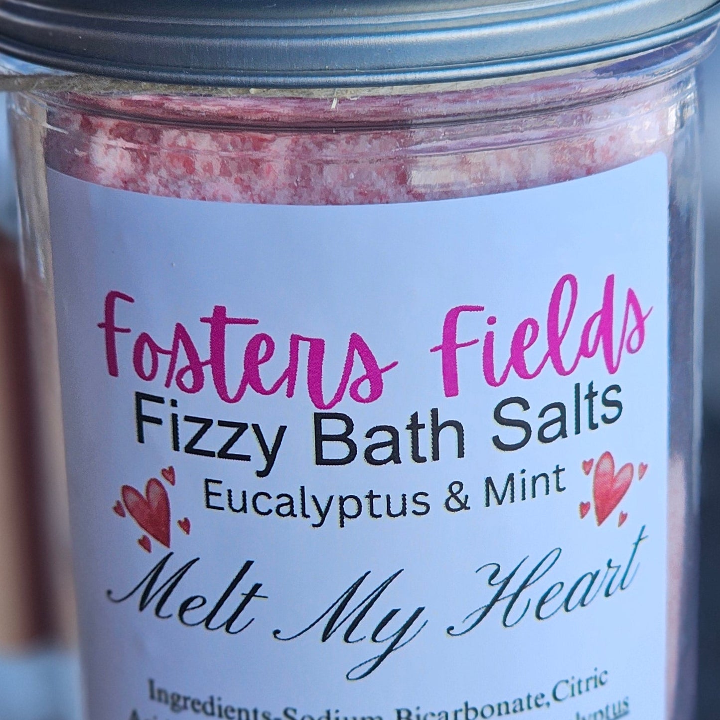Jar of Fosters Fields Fizzy Bath Salts with visible text on a blurred background