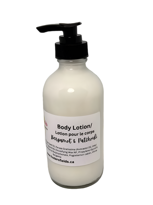 Handmade lotion scented with essential oils of Bergamot and Ptchouli packaged in a clear bottle.