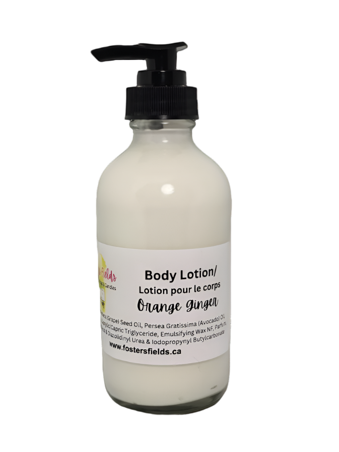 Handmade lotion scented with orange and ginger, packaged in a clear bottle.