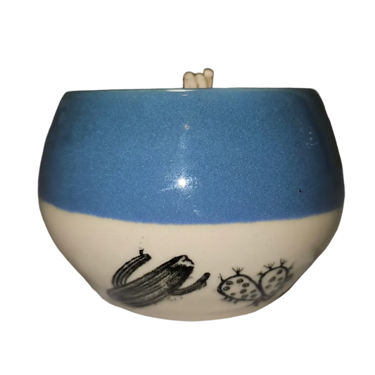 Ceramic bowl with blue top and white base on a white surface