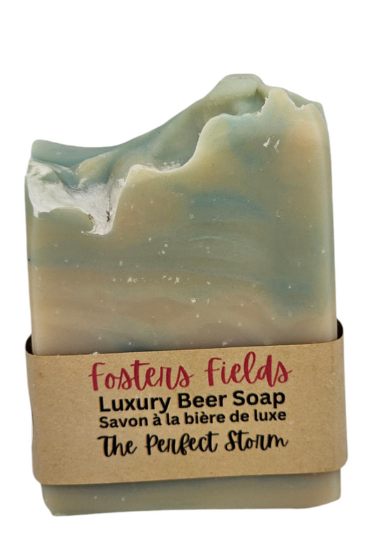 Here's the revised alt text:  "Manly scented Perfect Storm soap with a light blue swirl, 110g, ideal for all skin types, providing a refreshing and moisturizing cleanse."