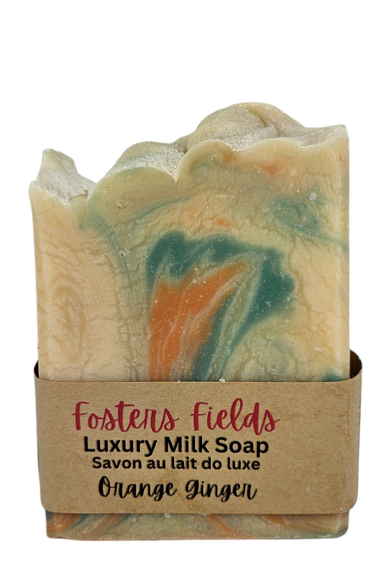 A bar of Orange Ginger Milk Soap with vibrant swirls of green and orange. The lively colors mix together, evoking a fresh and zesty aroma with a hint of citrus and spice.