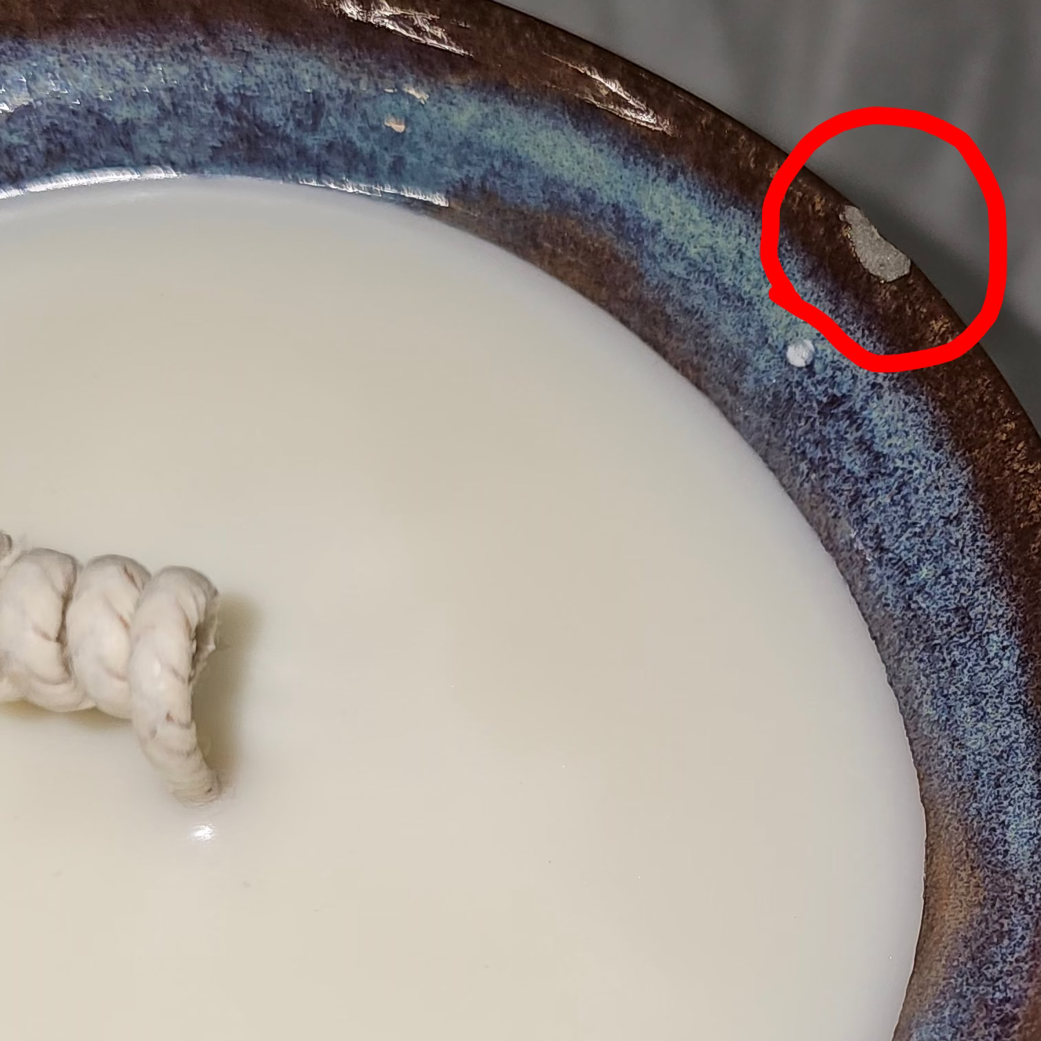 Upcycled soy candle in a pottery bowl, chip in bowl