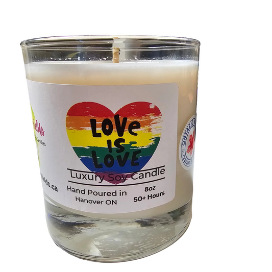 Candle in a glass jar with a 'Love is Love' rainbow pride label