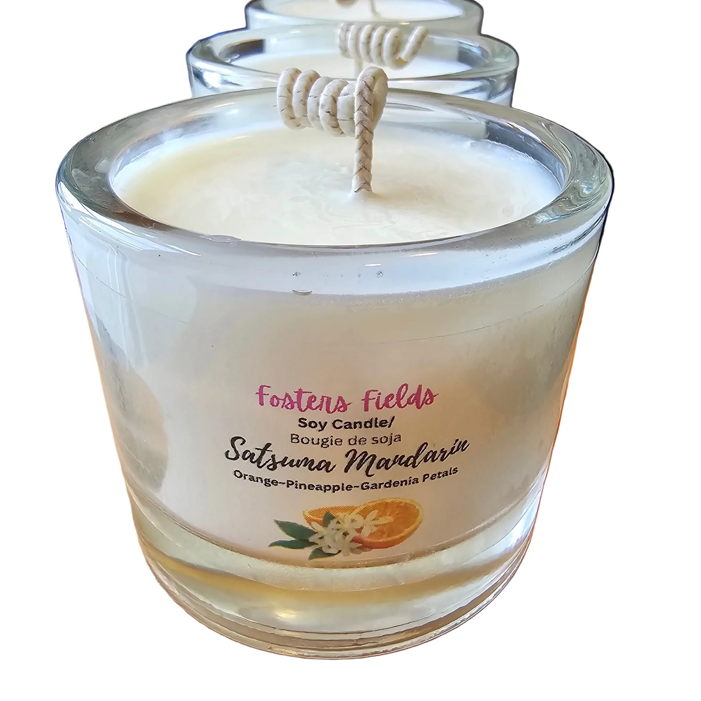 Scented candle in a glass jar with a label on a white background