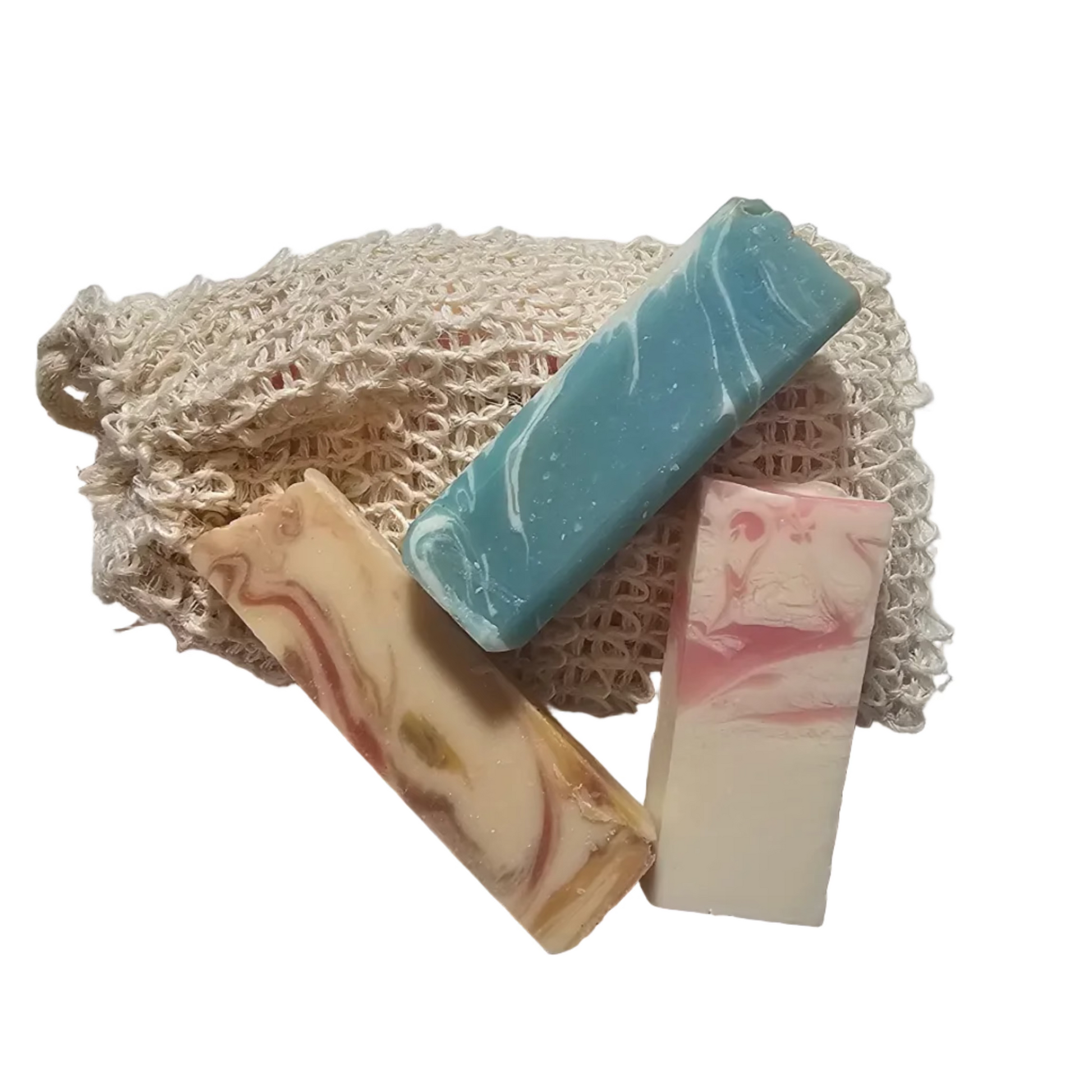 Three bars of soap with decorative designs on a white surface, with a mesh bag and tape measure in the background.