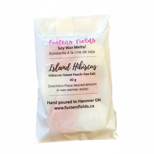 Soy wax melt packet labeled 'Island Hibiscus' on a dark surface