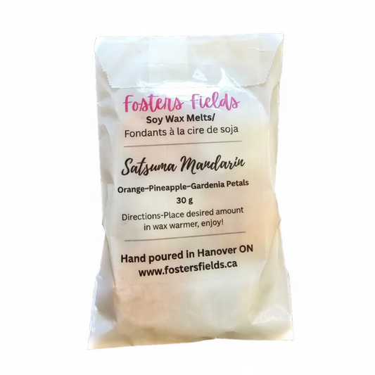 tiny flower soy wax scented with orange, packaged in glassine bag with a clear sticker label stating Fosters Fields