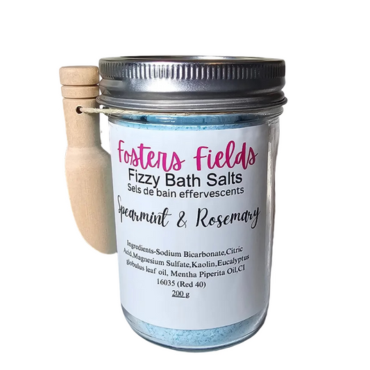 Jar of Fizzy Bath Salts on a shelf with 
simple white label and a scoop