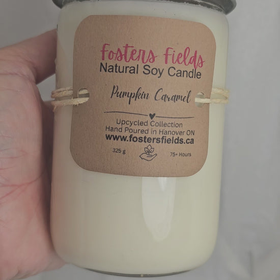 close up video of Pumpkin Caramel Soy Jar Candle, glass with glass and metls lid, some embossing on the upcycled jars nad lid