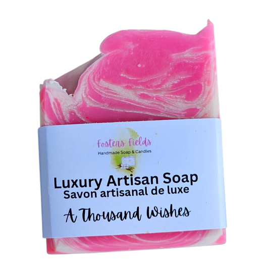 Pink and white marbled soap with a label on a white background, A Thousand Wishes scent, feminine pink and white swirls