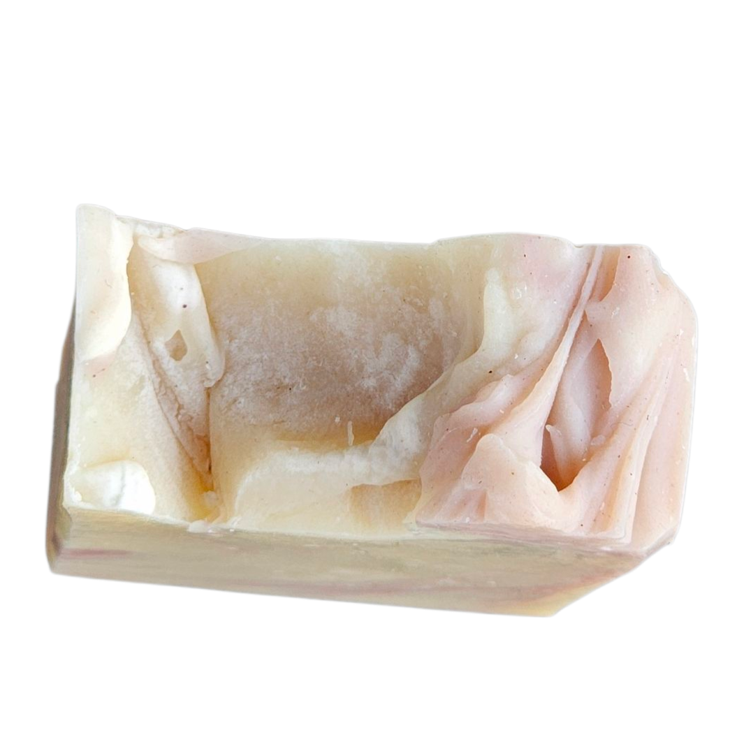 Rectangular stone soap dish with marbled pattern on a white background, top view of handmade soap bar
