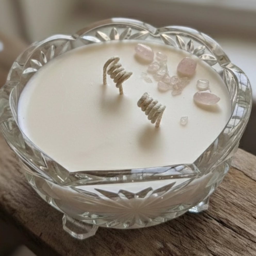 Upcycled candle in a decorative glass holder on a wooden surface with text overlay.