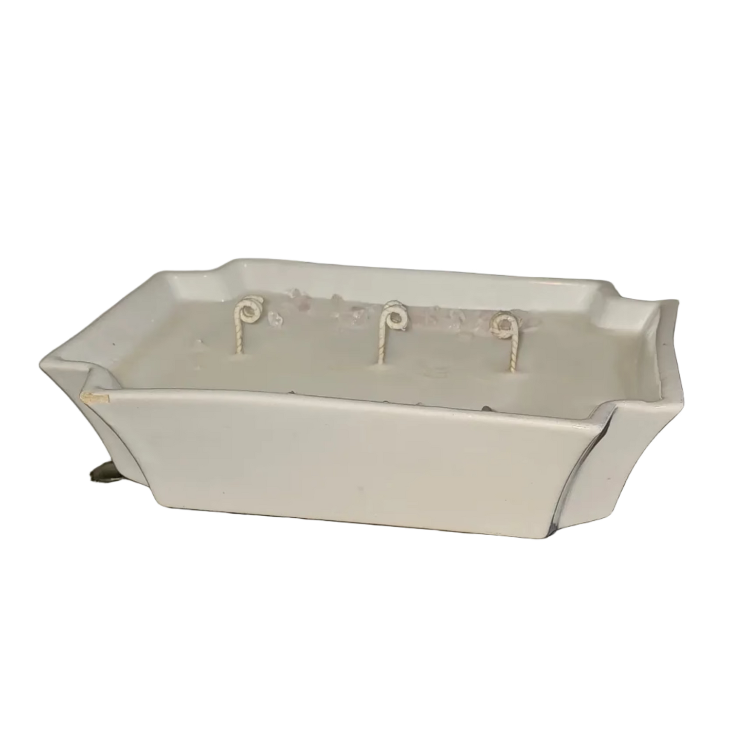 White rectangle bowl filled with soy wax, 3 wicks and rose quartz on top